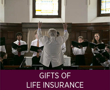 A teacher leading the choir. Links to Gifts of Life Insurance